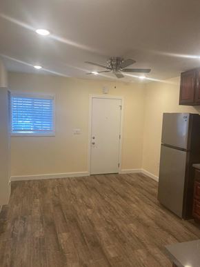 Compton apartment for rent - A kitchen with a refrigerator and a ceiling fan.