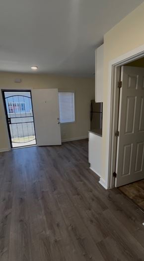 Los Angeles apartment for rent - A room with a white door and a window with a view of a building outside.