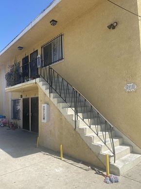 Los Angeles apartment for rent - A tan building with a black railing on the balcony.