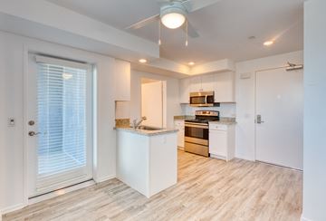 Los Angeles apartment for rent - a renovated kitchen with white cabinets and a door to the living room
