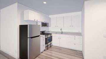 Los Angeles apartment for rent - A modern kitchen with white cabinets and stainless steel appliances.