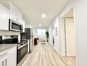 Los Angeles apartment for rent - A modern kitchen with white cabinets and stainless steel appliances.