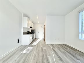 Los Angeles apartment for rent - A spacious kitchen with white cabinets and a grey floor.