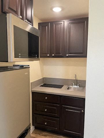 Los Angeles apartment for rent - A kitchen with brown cabinets and a white refrigerator.