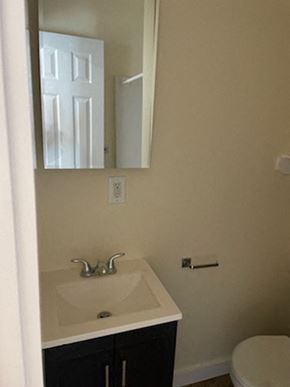 Los Angeles apartment for rent - A bathroom with a sink, mirror, and toilet.