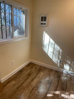 Los Angeles apartment for rent - A room with a window and a wall-mounted air conditioning unit.