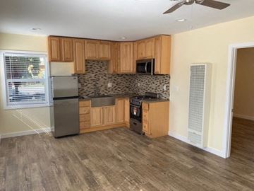 Los Angeles apartment for rent - A kitchen with wooden cabinets and a tile backsplash.