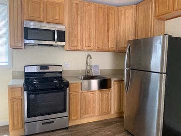 Los Angeles apartment for rent - A kitchen with wooden cabinets and a stainless steel refrigerator.