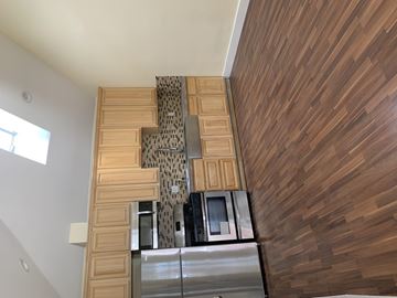 Los Angeles apartment for rent - A kitchen with wooden cabinets and a stainless steel refrigerator.