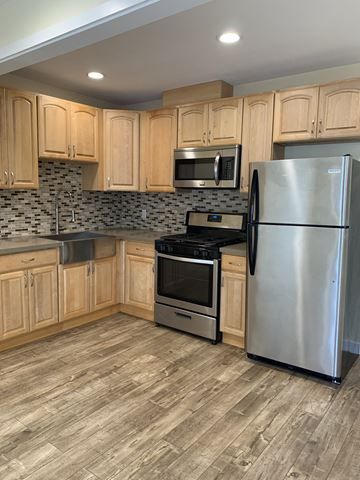 Los Angeles apartment for rent - A kitchen with wooden cabinets and a stainless steel refrigerator.