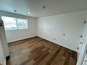 Los Angeles apartment for rent - A room with wooden flooring and white walls.