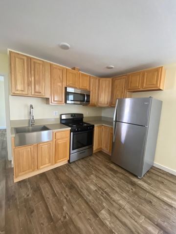 Los Angeles apartment for rent - A kitchen with wooden cabinets and a stainless steel refrigerator.