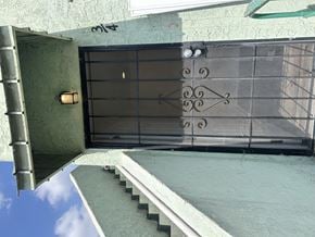 Los Angeles apartment for rent - A black gate with a decorative design is closed.