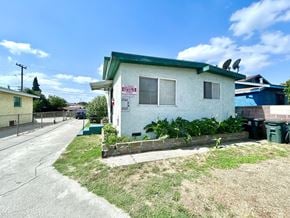 Los Angeles apartment for rent - A white house with a green roof and a sign that reads "For Sale".