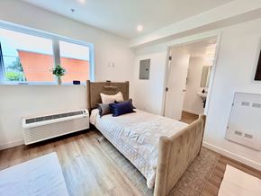 San Pedro apartment for rent - A bedroom with a large bed and a window.