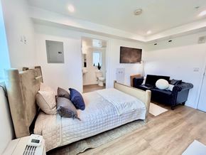 San Pedro apartment for rent - A bedroom with a large bed and a couch.