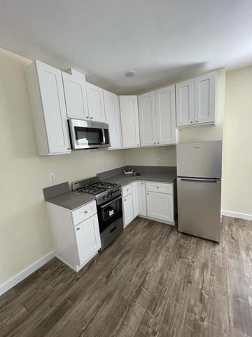Los Angeles apartment for rent - A kitchen with white cabinets and a stainless steel refrigerator.