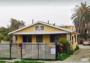 Los Angeles apartment for rent - A yellow house with a black and white fence.
