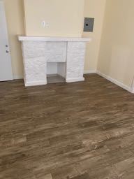 Los Angeles apartment for rent - A white fireplace in a room with wooden flooring.