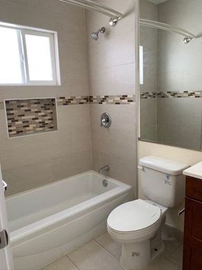 Los Angeles apartment for rent - A white toilet sits next to a bathtub in a bathroom.