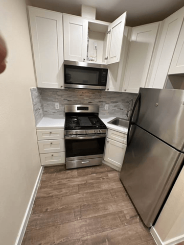 Los Angeles apartment for rent - A kitchen with a refrigerator, oven, and microwave.