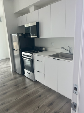 Los Angeles apartment for rent - a kitchen with a stove a sink and a microwave