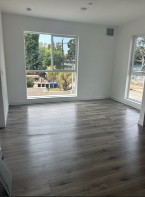 Los Angeles apartment for rent - an empty room with a large window and hardwood floors