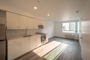 Los Angeles apartment for rent - A kitchen with white cabinets and a wooden floor.