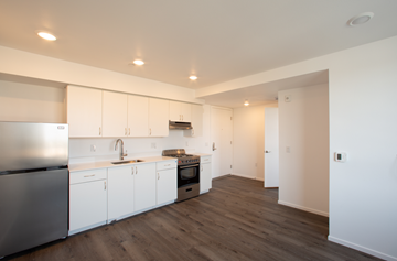 Los Angeles apartment for rent - A kitchen with white cabinets and a stainless steel refrigerator.