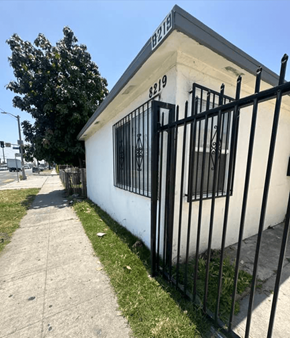 Los Angeles apartment for rent - the side of a building with a fence and a sidewalk