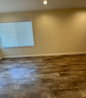 Los Angeles apartment for rent - an empty living room with wood floors and a window