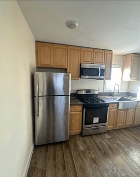Los Angeles apartment for rent - A kitchen with a stainless steel refrigerator, microwave, and stove.
