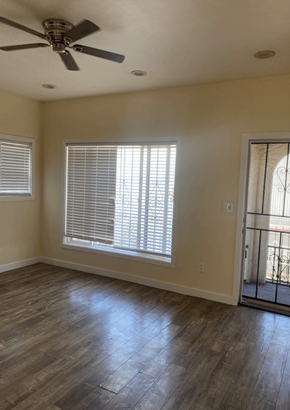 Los Angeles apartment for rent - a living room with a large window and a ceiling fan