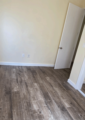 Los Angeles apartment for rent - a room with wood flooring and white walls and a door
