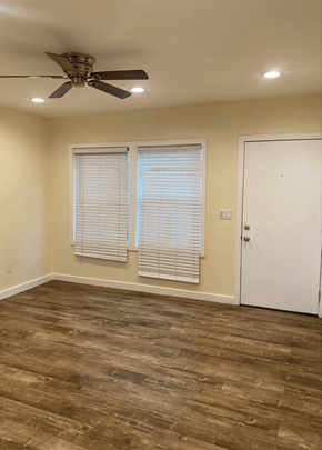 Los Angeles apartment for rent - an empty living room with a ceiling fan and two windows