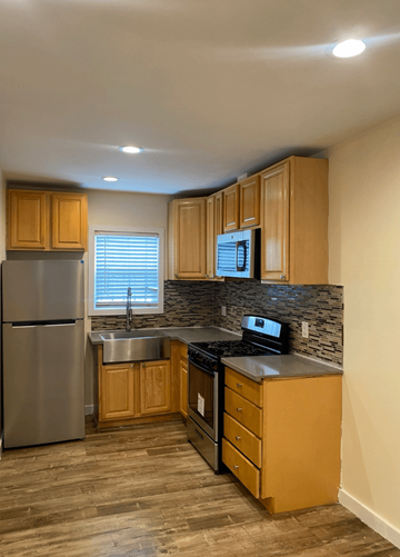 Los Angeles apartment for rent - A kitchen with wooden cabinets and a stainless steel refrigerator.