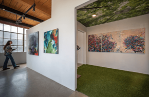 Los Angeles apartment for rent - a woman walking through an art gallery with paintings on the wall