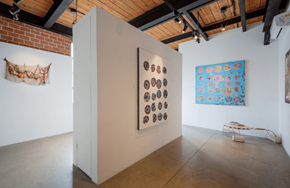 Los Angeles apartment for rent - a display case in a room with paintings on the wall