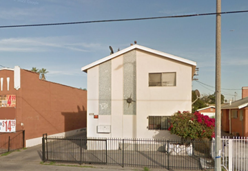Los Angeles apartment for rent - A small house with a white door and a window is surrounded by a black fence.