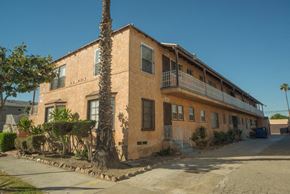 Los Angeles apartment for rent - A building with a balcony and a tree in front of it.