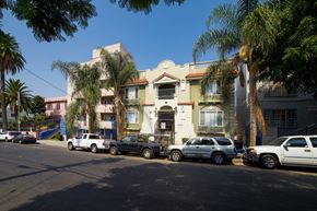 Los Angeles apartment for rent - A street view of a row of houses with cars parked in front.