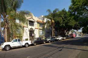 Los Angeles apartment for rent - Cars parked on a street in front of a building.