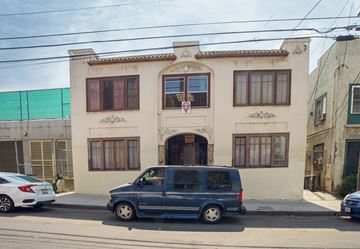Los Angeles apartment for rent - A blue van is parked in front of a two-story building.