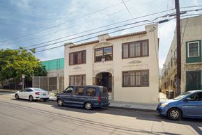 Los Angeles apartment for rent - A blue van is parked in front of a building.