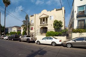 Los Angeles apartment for rent - Cars parked on a street in front of a building.