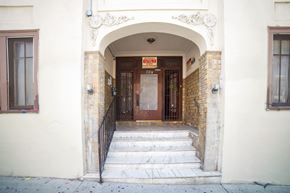 Los Angeles apartment for rent - A building with a brown door and a sign above it.