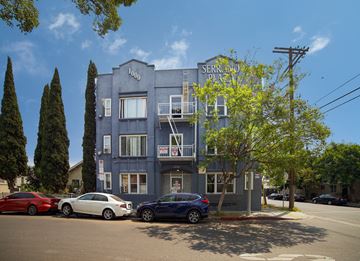 Los Angeles apartment for rent - A blue building with the words "Serrano Plaza" on it.