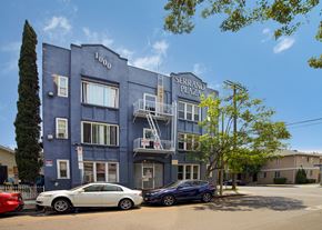 Los Angeles apartment for rent - A blue building with the number 1000 on it and the words "Serrano Plaza" above the entrance.