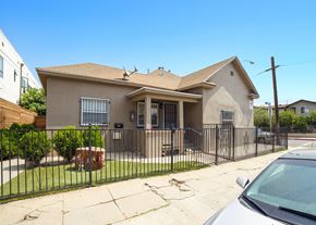 Los Angeles apartment for rent - A house with a brown roof and a white car parked in front.