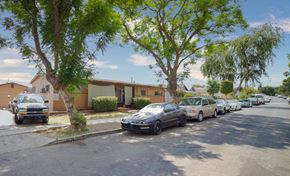 Los Angeles apartment for rent - A row of cars parked on a street in front of houses.